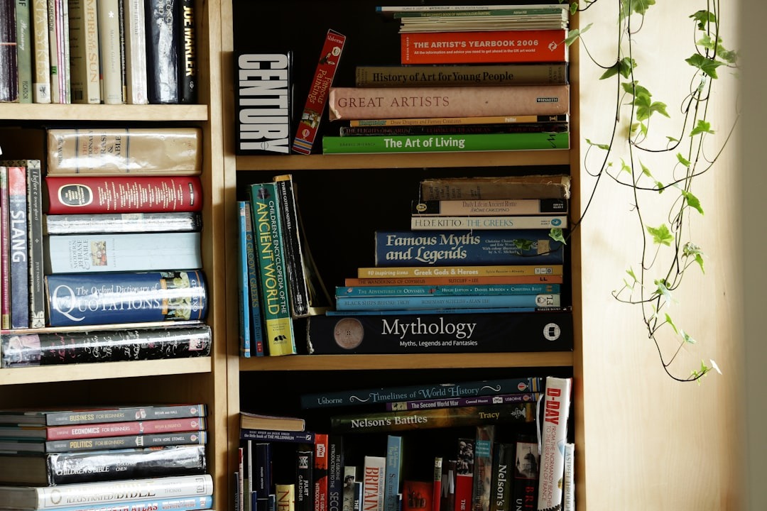 Wooden bookshelf holding history, mythology, art, and literature books with ivy.